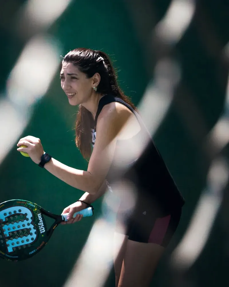 Padel player ready behind the fence